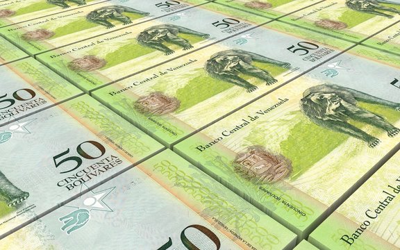 Venezuelan Bolivares bills stacks background.