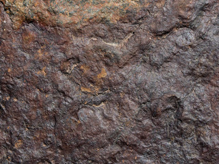 Rock texture: close-up of a red-brown stone useful as background