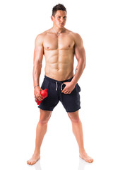 Fototapeta na wymiar Muscular young man holding protein shake bottle