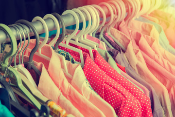 Fototapeta Clothes hang on a shelf in a designer clothes store in retro col obraz