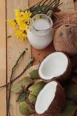 Fototapeta na wymiar white coconut and milk on wood background