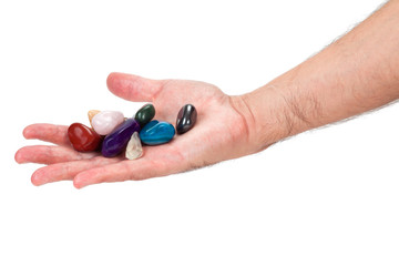 Hand holding beautiful colorful gem stones