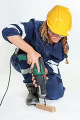 Young girl with helmet and work the drill