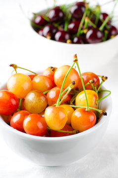 Red and yellow cherries in bowl