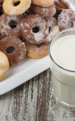 Seet fresh cookies with a cup of milk over wooden vintage background