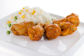 Curry chicken with rice on a white plate