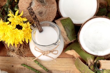 white coconut and milk on wood background
