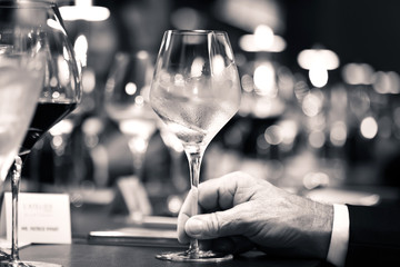 black and white of white wine on hand with dinner on restaurant