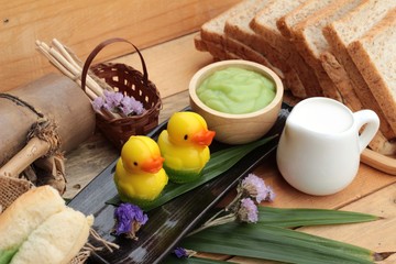 Bread with green custard and fresh milk.