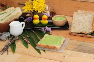 Bread with green custard and fresh milk.