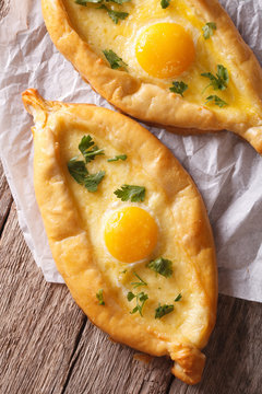 Ajarian khachapuri, with egg and cheese closeup. vertical top view
