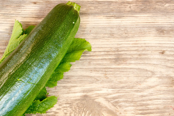 zucchinis on wood background with copy space
