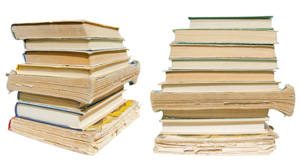 две стопки старых книг на белом фоне