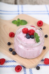 Yogurt and ripe blueberries and raspberries
