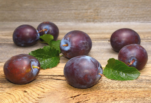Fresh plums on wooden background