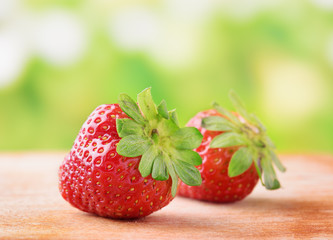 Fresh ripe red sweet strawberries on wooden board