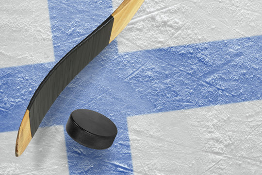 Hockey puck, hockey sticks and ice rink