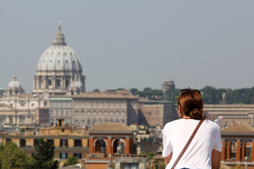 Panoramic view of Rome with tourist watching Basilica of St. Peter in Vatican