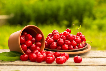 Cherries on wooden table with water drops macro background