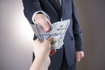 Businessman with money in studio on a gray background