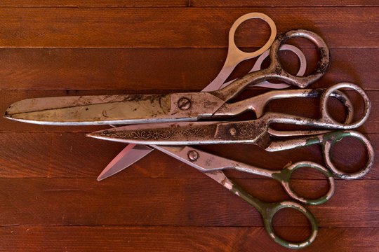 Old scissors on wooden background