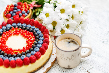 Raspberry and blueberry cheesecake on wooden table