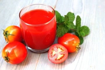 Glass of tomato juice with fresh tomatoes