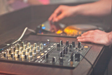 DJ mixing music on console