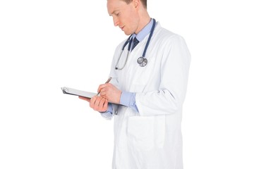 Serious doctor writing on a clipboard