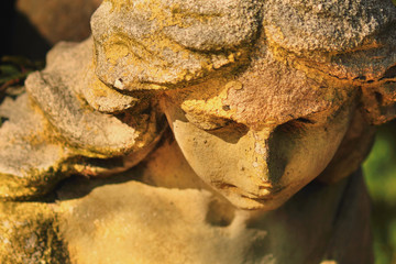 Vintage image of a sad angel on a cemetery (fragment)