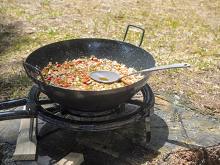 Coocking  a vegetarian paella at picnic