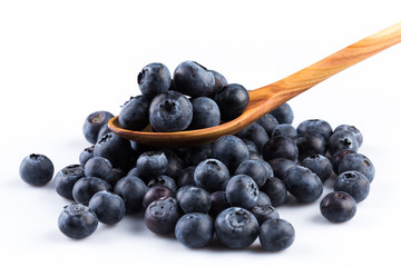 Fresh blueberries in wooden spoon