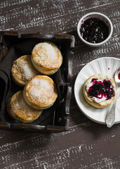 English scones for Breakfast in a vintage tray on brown wooden background