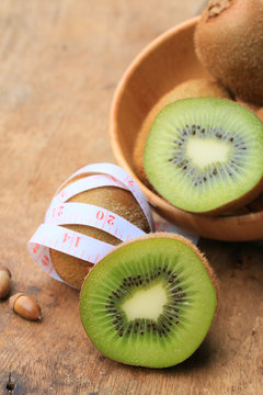 fresh kiwi fruit and tape measure