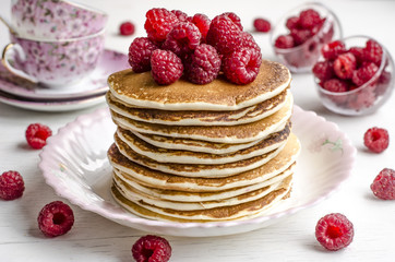 Pancake with sauce and raspberries  