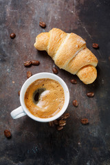 Hot coffee and a croissant