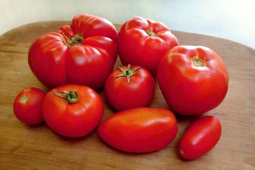 Homegrown organic tomatoes on the wooden desk