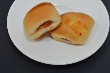 bun filling bacon and cheese on dish