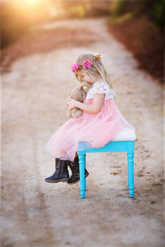 Girl sitting on a stool with her bunny rabbit