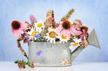 watering can with wildflowers