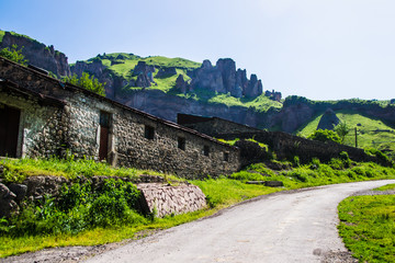 Fototapeta na wymiar Stone construction, road and rocks on background, Armenia Goris