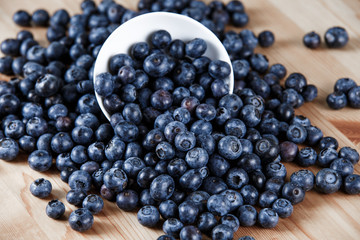 Fresh Organic Blueberries on wooden table. Background