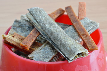 dog food crispy salmon skin and chicken soft stick on bowl