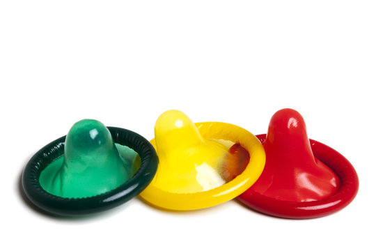 three colourful condoms on white background
