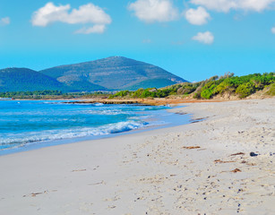 Maria Pia beach under a blue sky with clouds