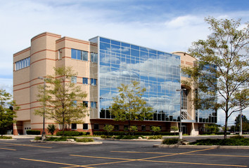 Office Building – An office building with glass windows on a sunny day.