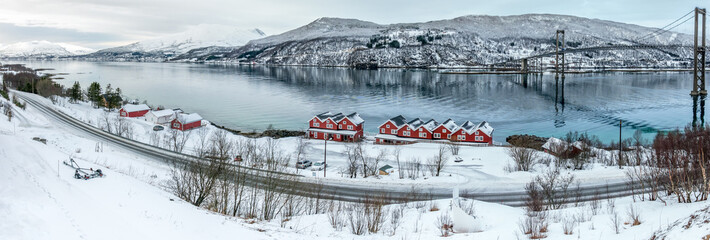 Rorbu fisherman's cabins and Tjeldsund Strait with bridge between mainland and Hinnoya island in Troms, Norway
