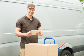 Delivery Man With Digital Tablet And Boxes