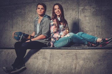 Young couple with skateboard outdoors