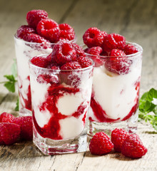 Raspberry ice cream with berries and mint, served in glasses on